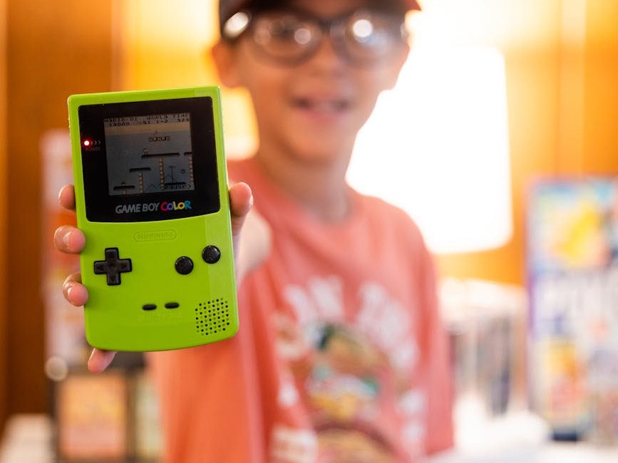 kid showing his vintage game boy color