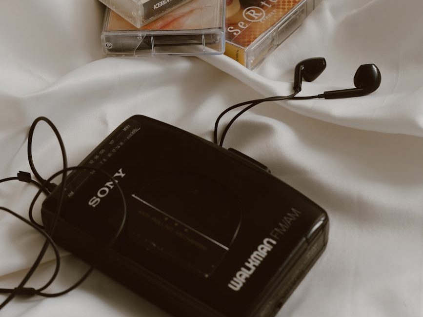 cassettes walkman with earphone on white cloth