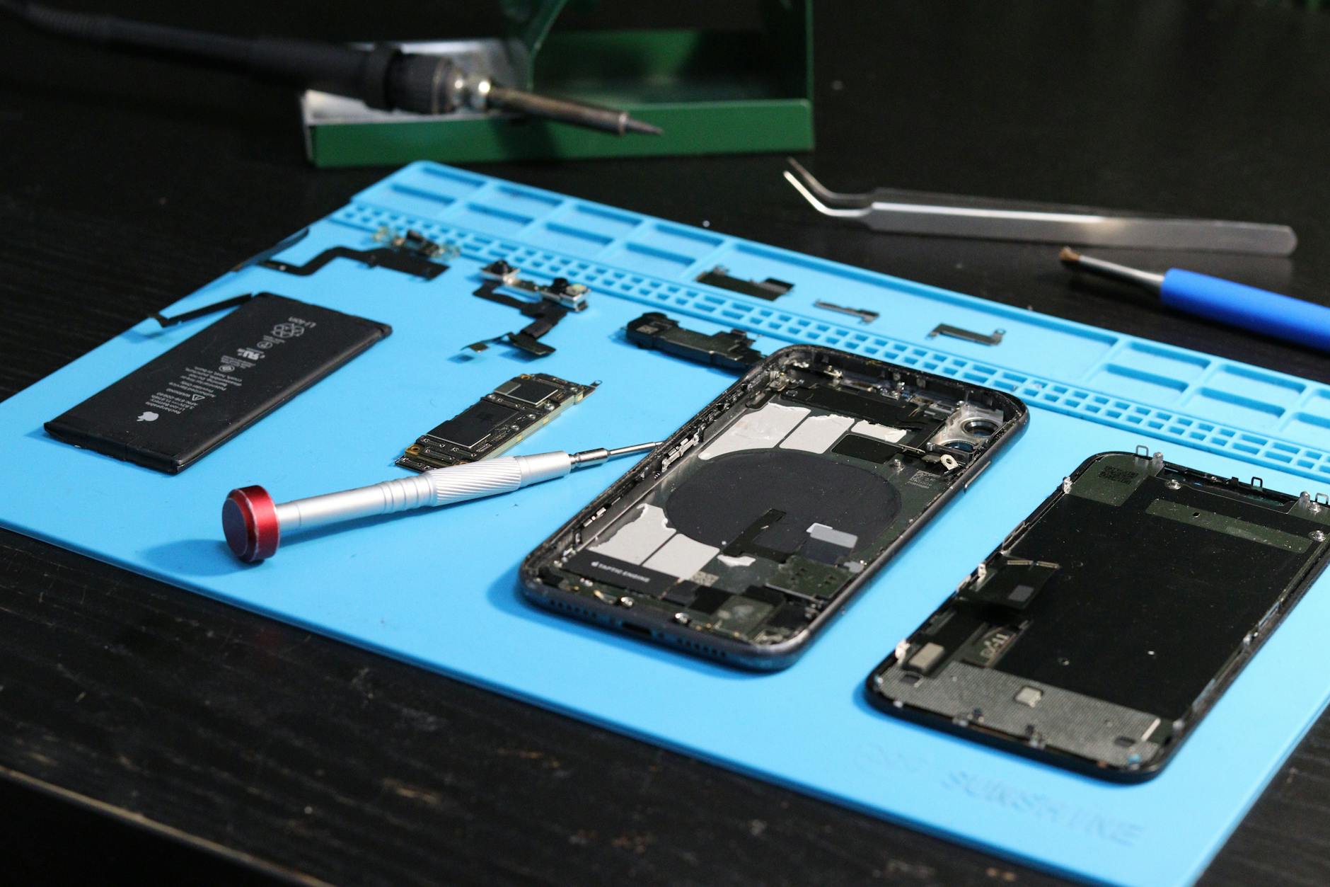 disassembled smartphone on repair workbench