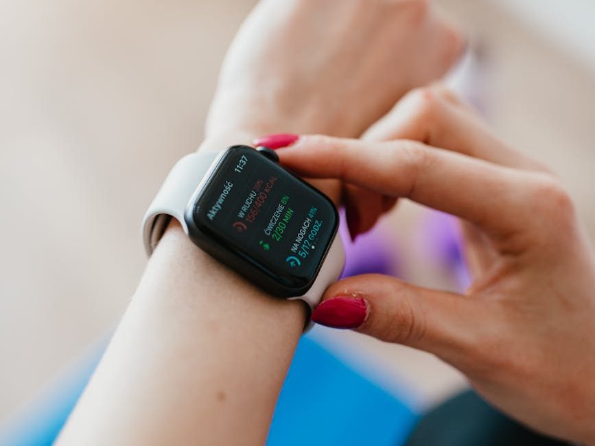 crop woman using smart watch on yoga mat